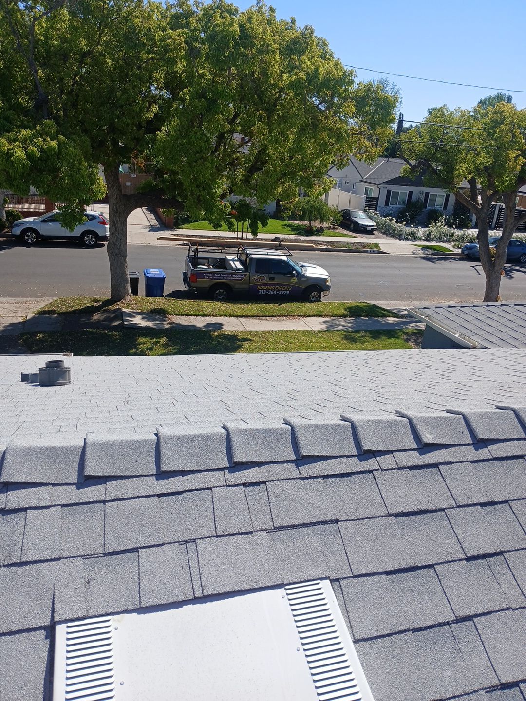 1-Mar 19 2026 10_59am-ZgH3 Rooftop view of suburban street and roofing van
