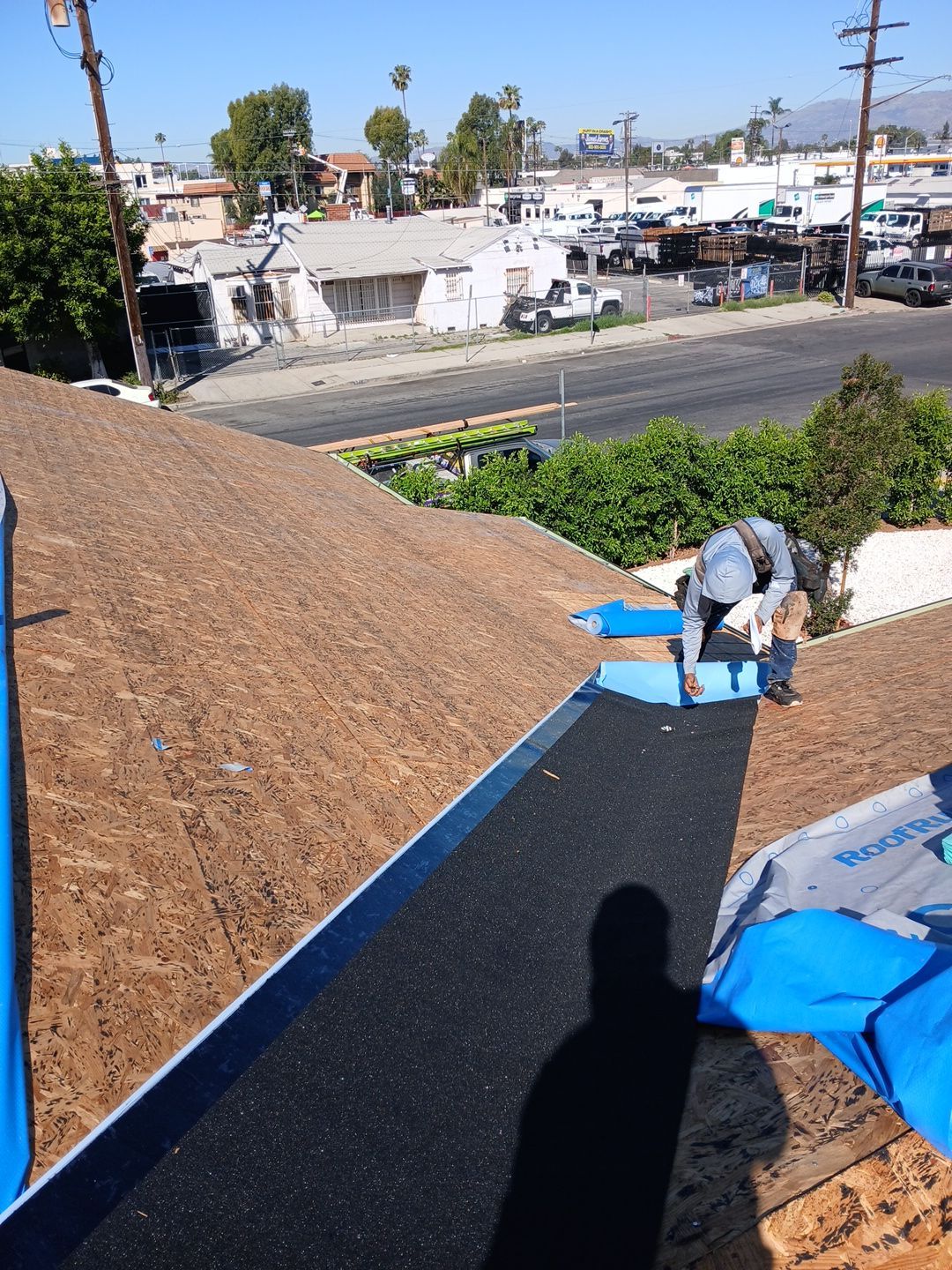 1-Mar 20 2026 10_27am-9UKv Worker installing roofing underlayment on residential roof