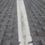Asphalt shingle roof with white valley membrane