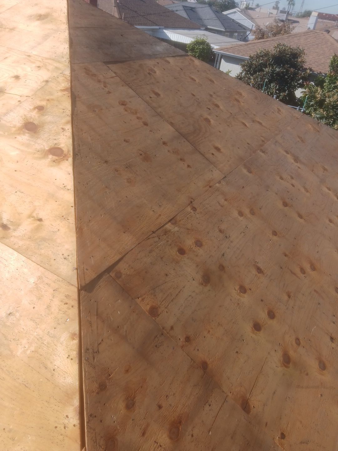 1-Nov 28 2025 09_47am-KxrN Plywood roof deck under construction in neighborhood