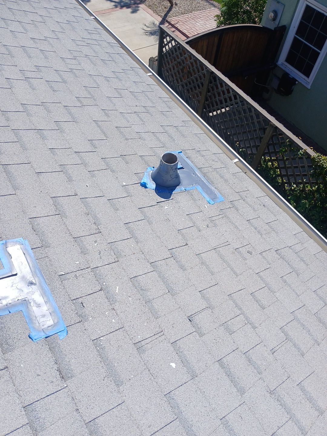 Residential shingle roof with vent pipe flashing