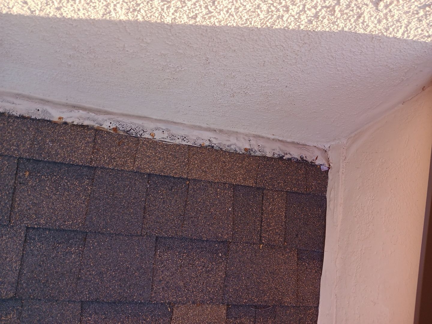 14-Mar 17 2026 08_00am-KPKm Roof shingles meeting stucco wall with flashing