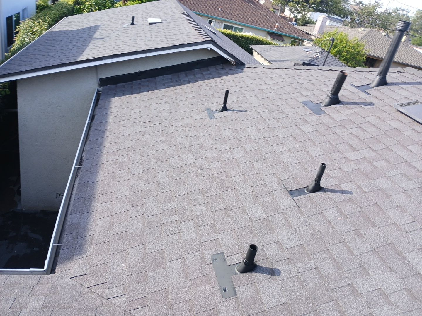 Residential shingle roof with multiple vent pipes