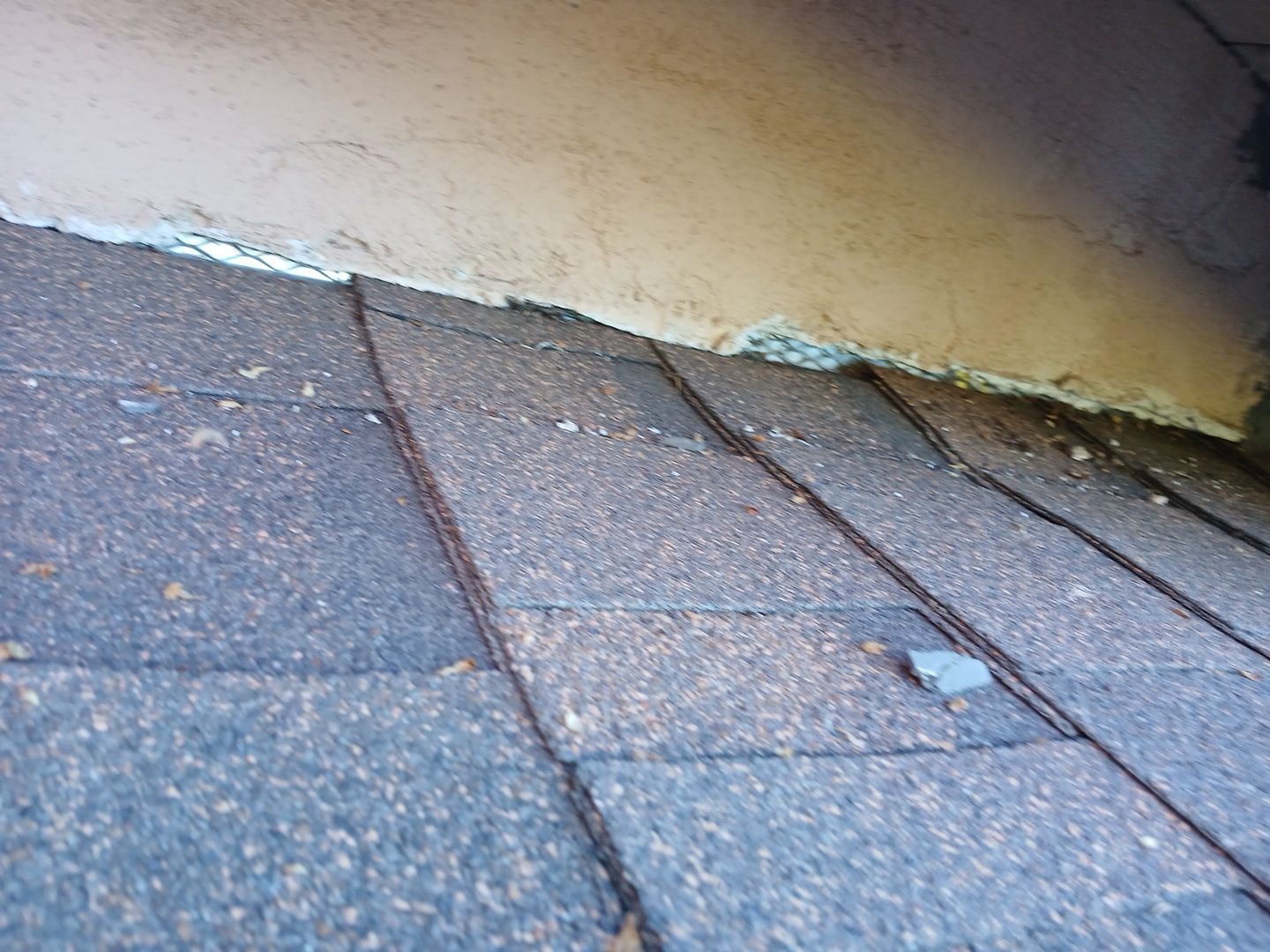 18-Mar 17 2026 08_01am-m1Q9 Roof shingles meeting stucco wall with flashing