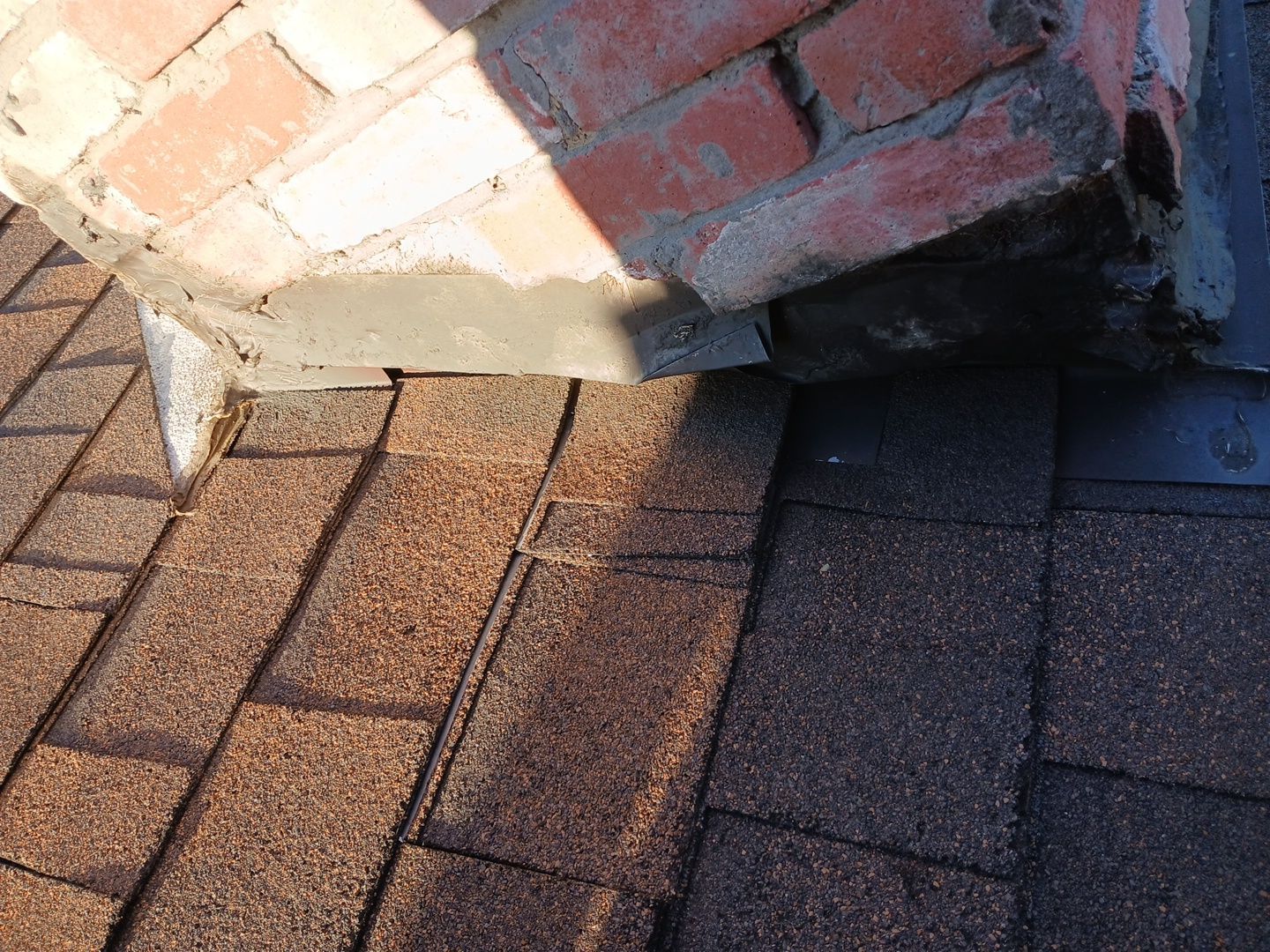 2-Mar 17 2026 07_59am-FHnb Roof shingles and brick chimney with metal flashing