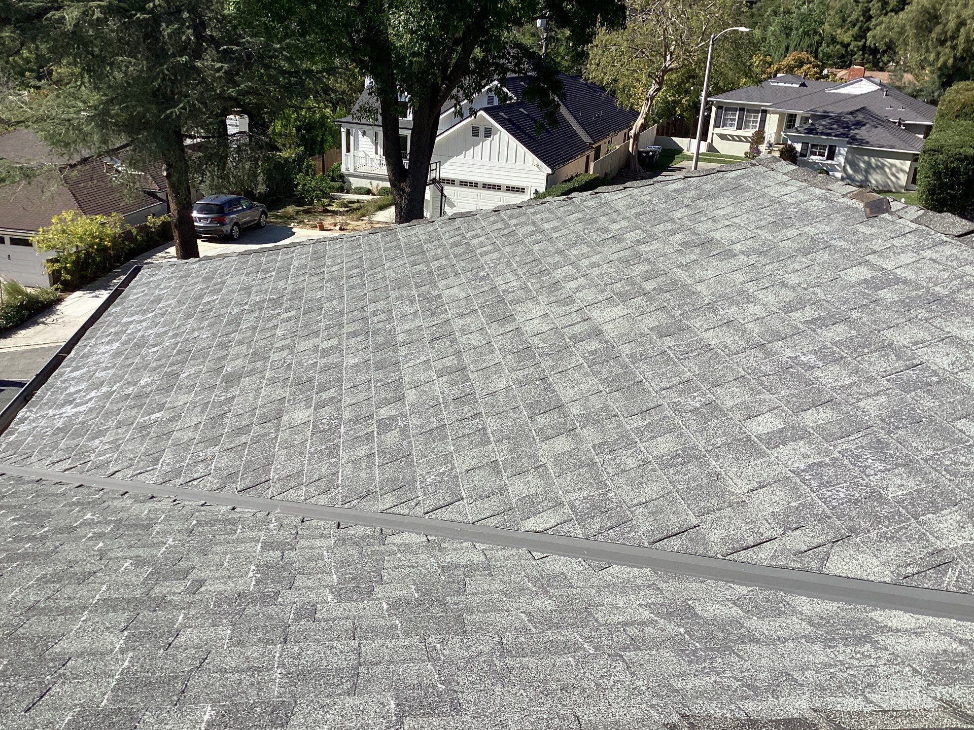 Gray shingle roof overlooking suburban neighborhood