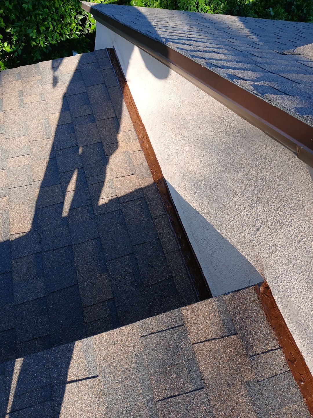 31-Mar 17 2026 08_50am-qZam Shadow on shingled roof beside stucco wall