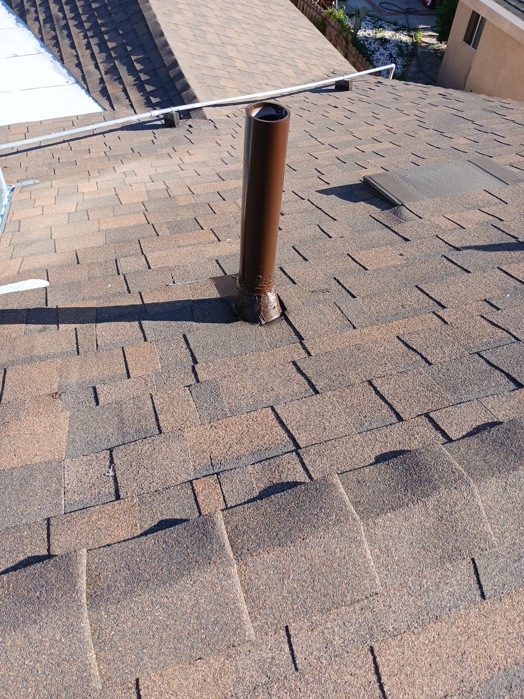 33-Mar 17 2026 08_50am-8mK1 Metal vent pipe on shingled residential roof