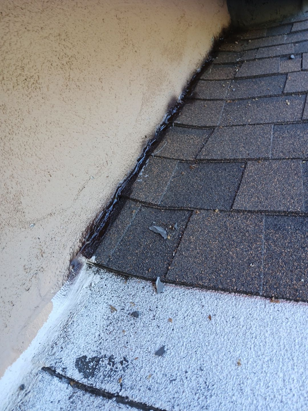 35-Mar 17 2026 08_51am-7Wjy Roof shingles meeting stucco wall with flashing