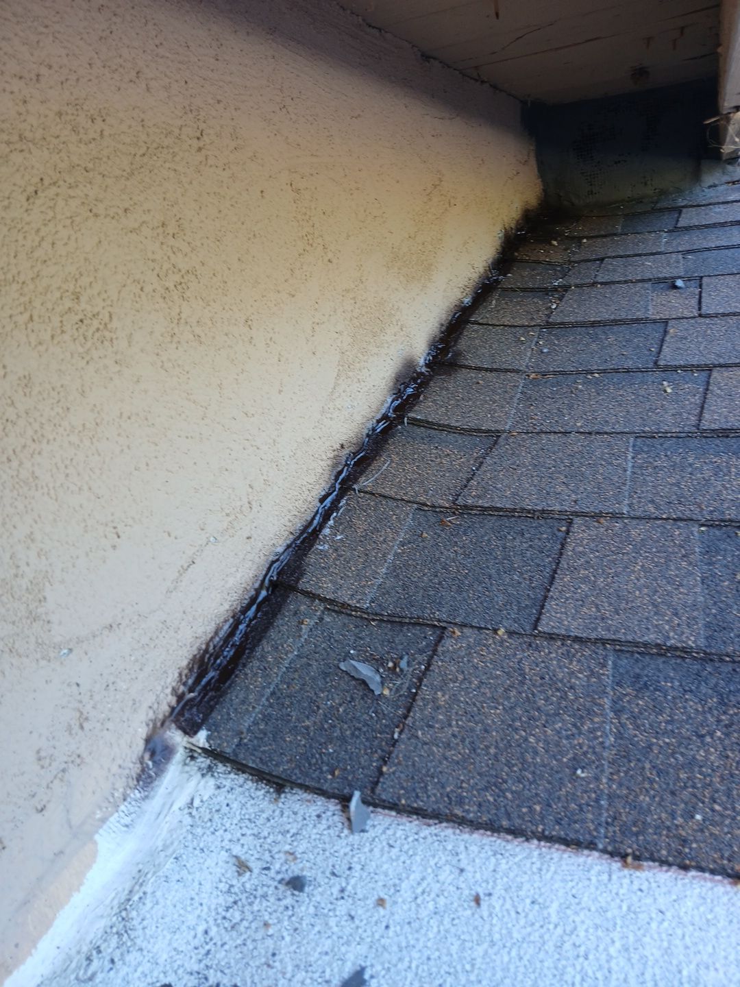 36-Mar 17 2026 08_51am-gMH9 Roof shingles meeting stucco wall with flashing