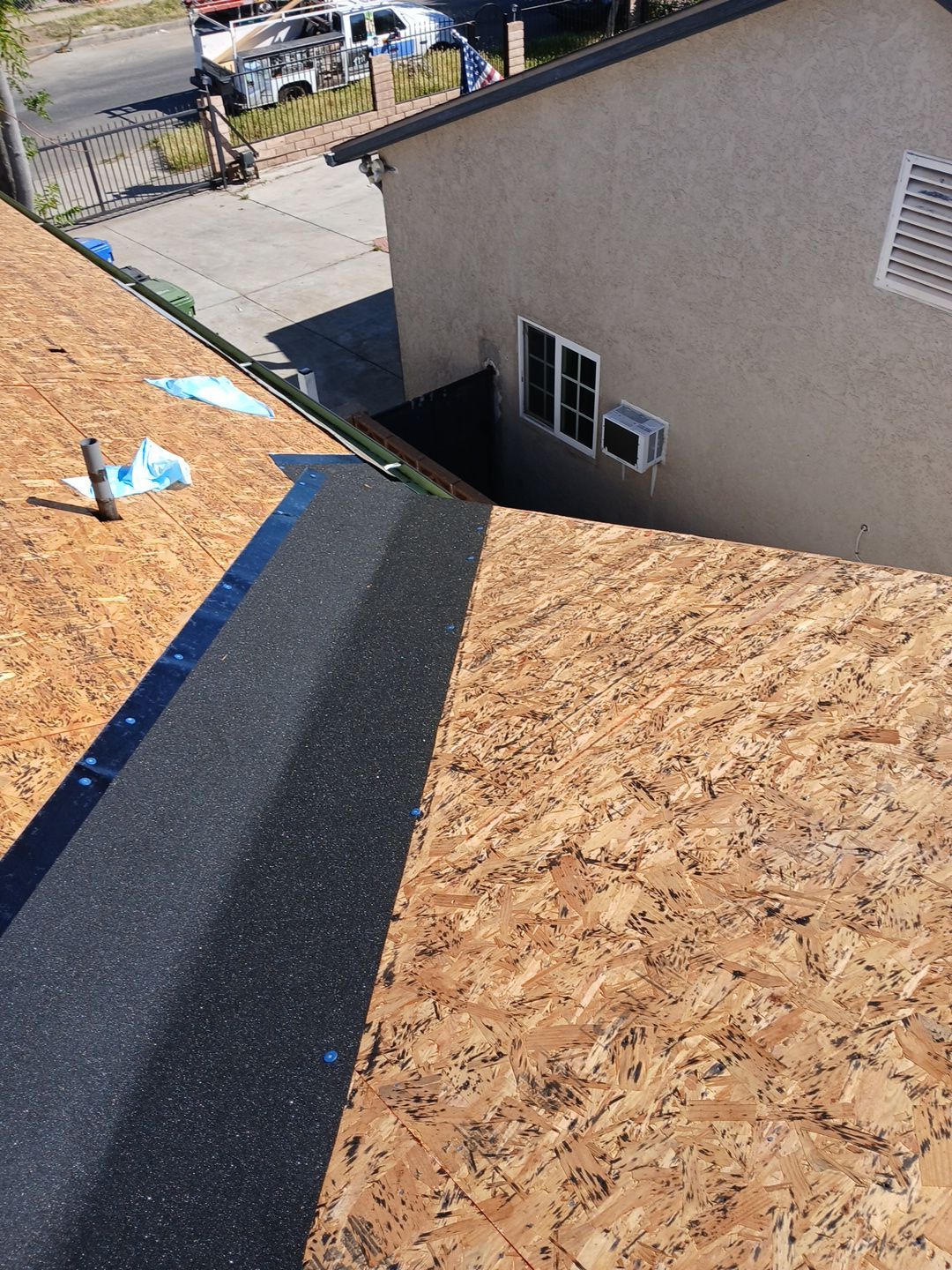 4-Mar 20 2026 10_27am-T9sP Residential roof under construction with plywood sheathing