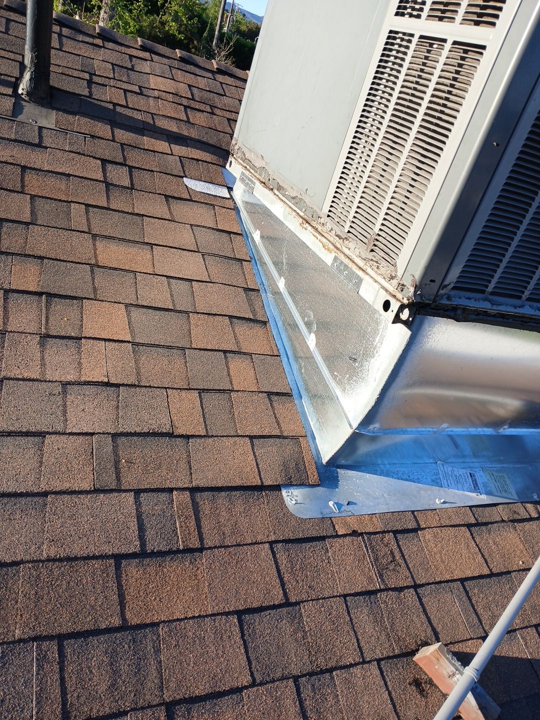 6-Mar 17 2026 08_00am-1NJb Rooftop HVAC unit with metal flashing on shingles