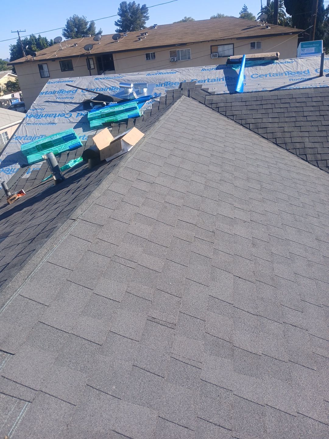Residential roof with new shingles installation in progress