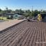 Roofer working on residential shingle roof