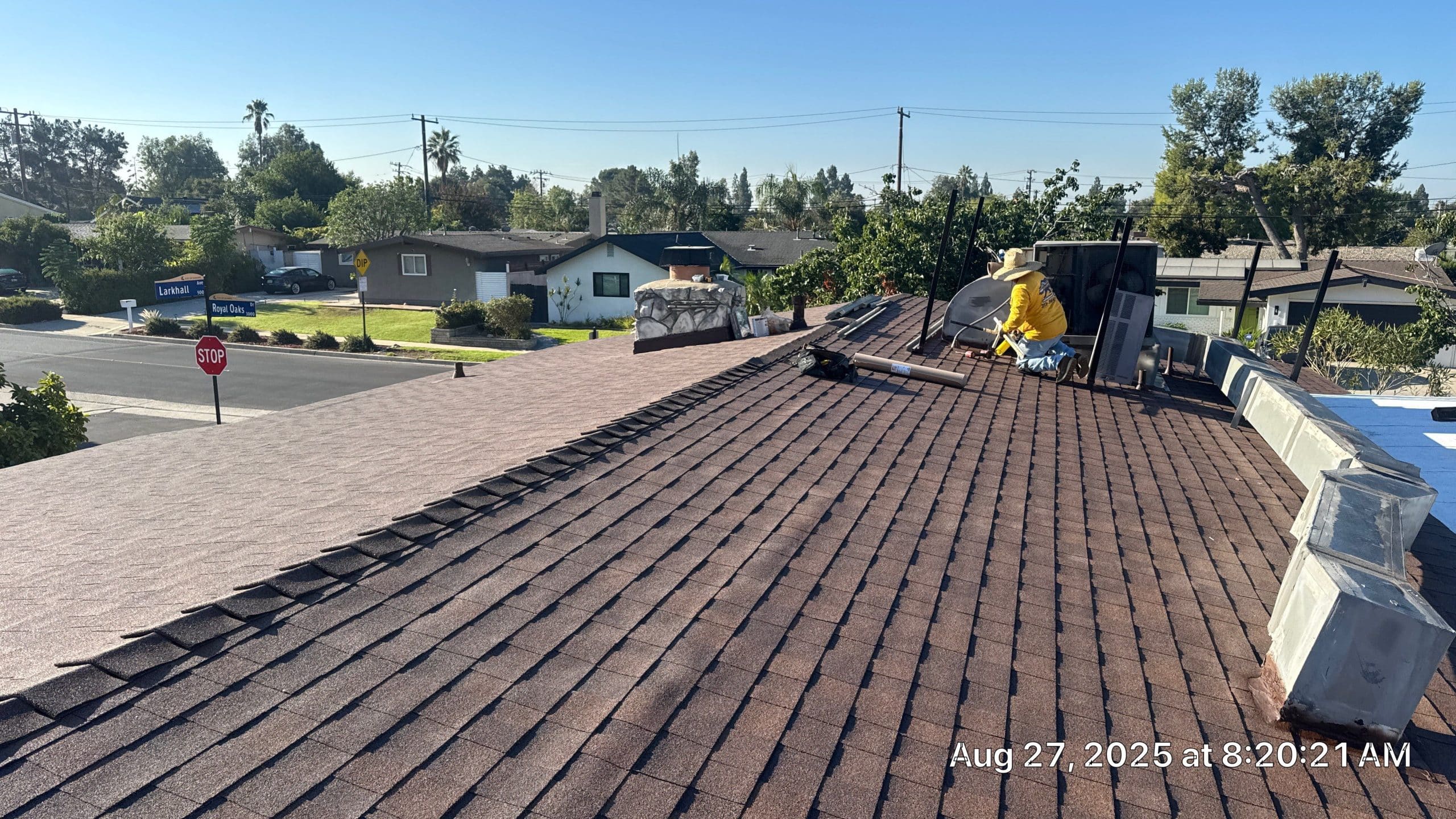 Roofer working on residential shingle roof