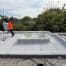 Worker using leaf blower on flat rooftop