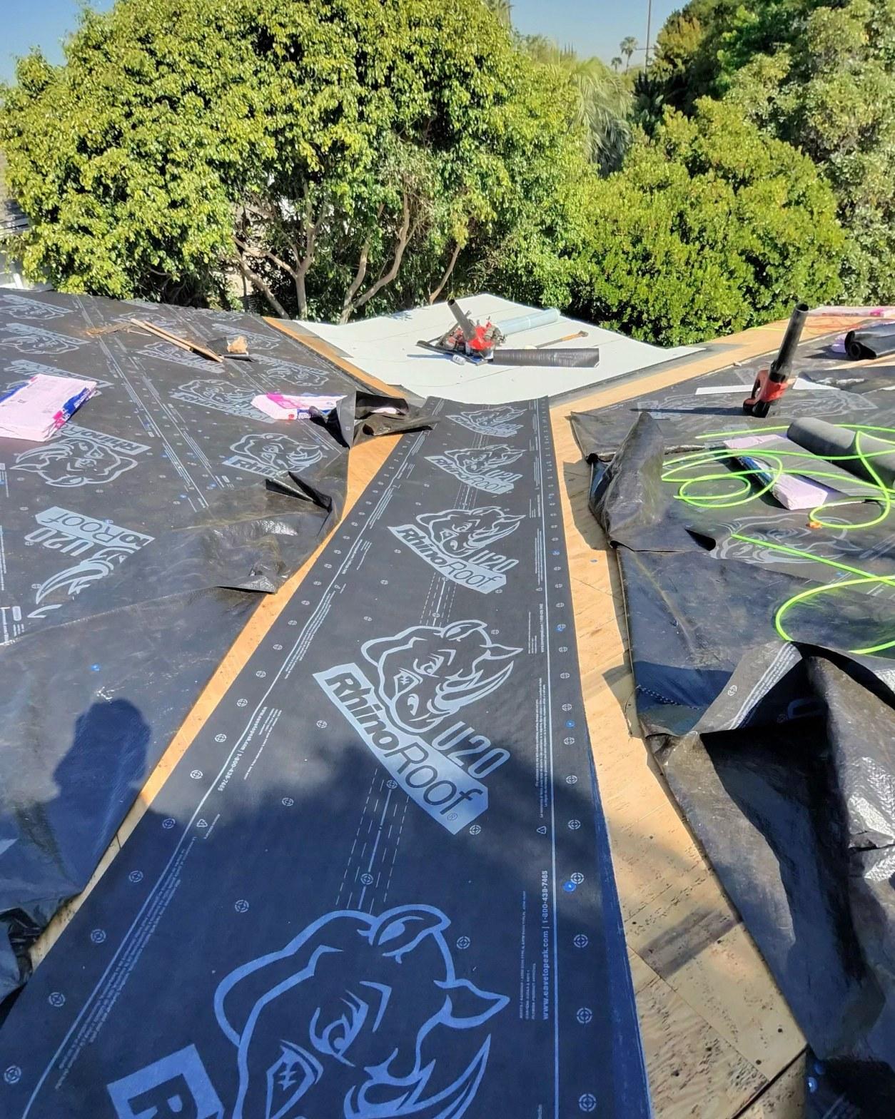 shingle-reroof-14819-sutton-st-los-angeles-569 RhinoRoof U20 synthetic roofing underlayment laid over plywood decking at roof valley junction during re-roof installation.