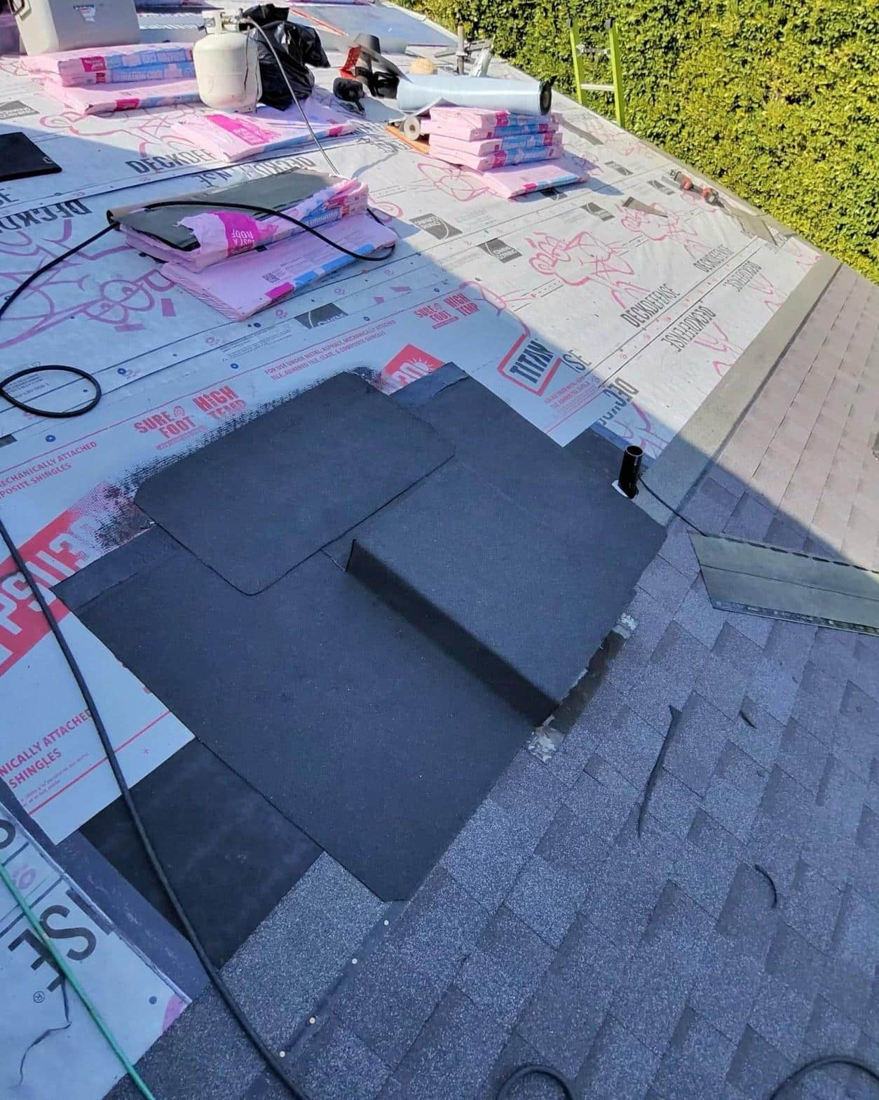 shingle-reroof-motor-ave-los-angeles-609 Roofing underlayment and ice-and-water shield partially installed on residential roof deck with new asphalt shingles started.