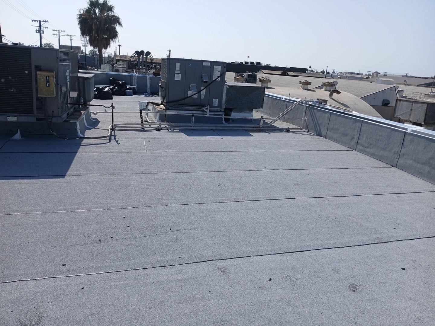 Multiple rooftop HVAC units on a deteriorated flat commercial roof in Vernon CA before torch down overlay