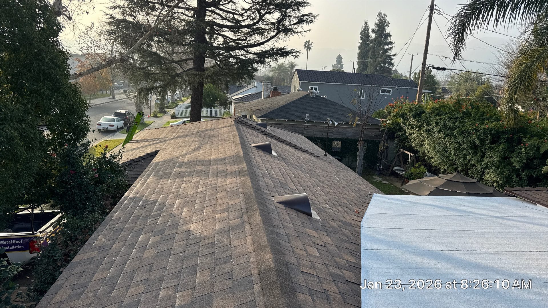 aged asphalt shingle roof with roof vents and tree overhang — Burbank — Roof Replacement Inc