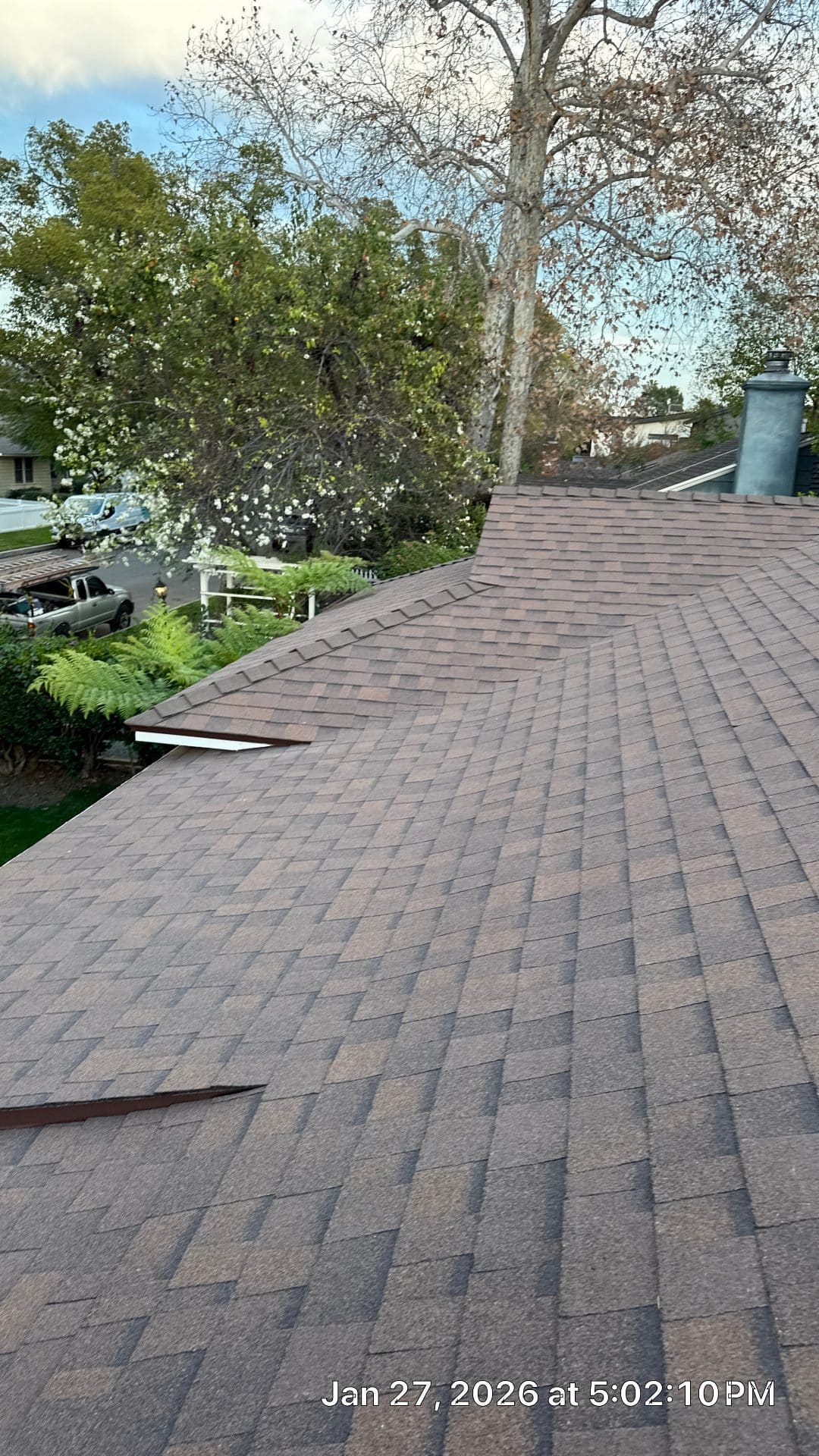 Completed asphalt shingle roof with hip ridge and chimney | Roof Replacement Inc Completed asphalt shingle roof with hip ridge and chimney — Roof Replacement Inc