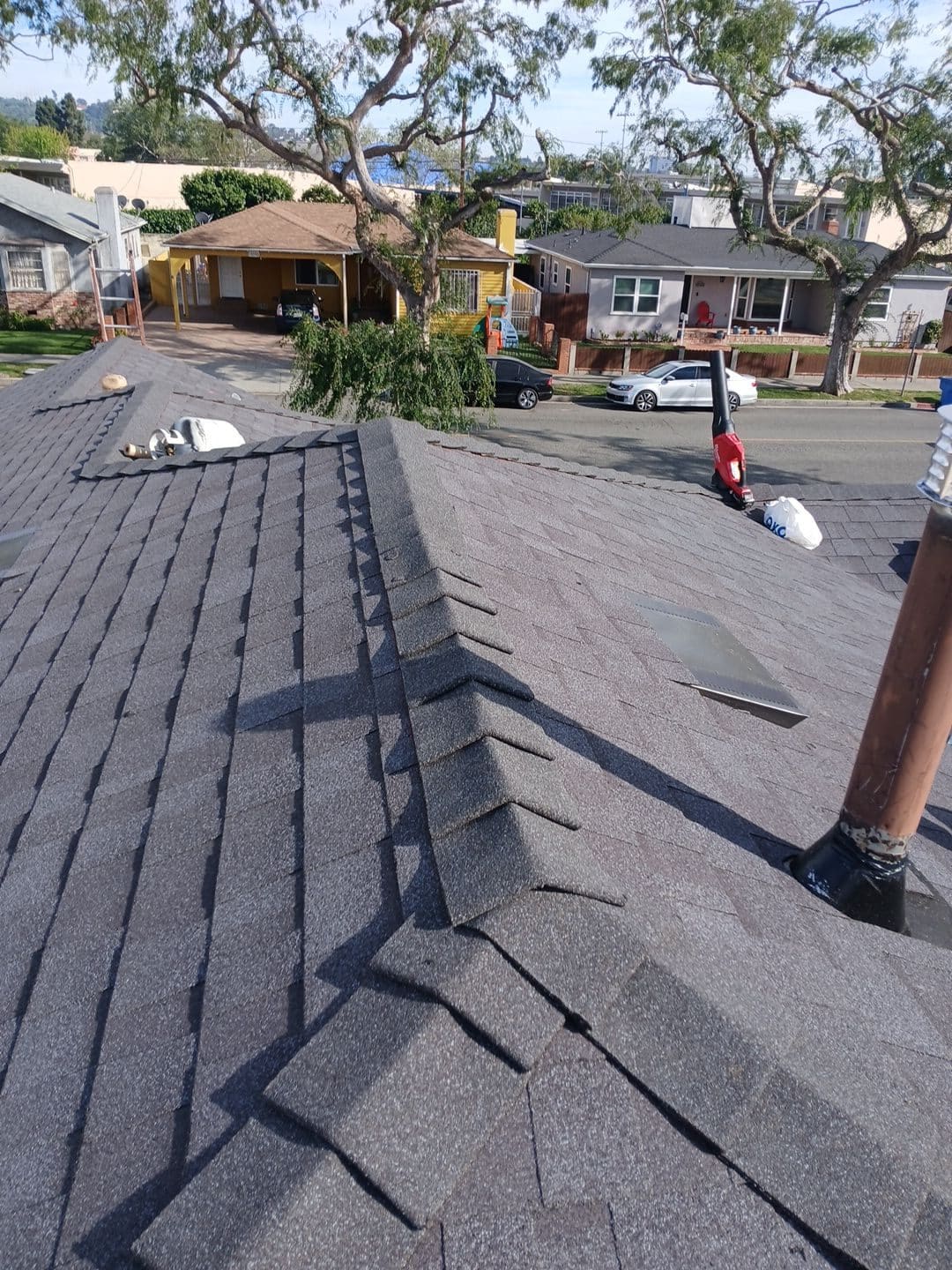 Gray asphalt shingle roof with hip ridge and pipe flashing — Roof Replacement Inc