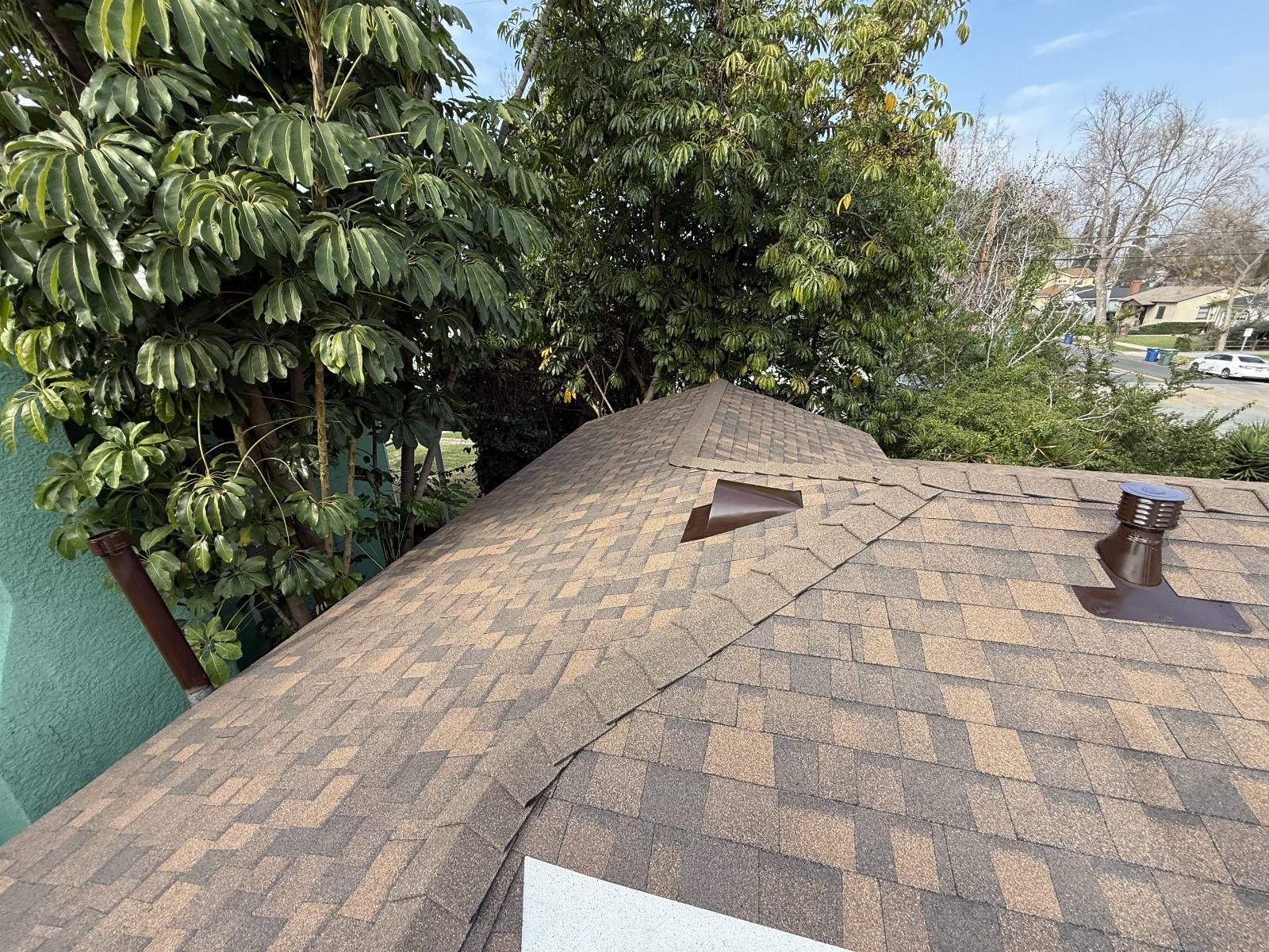 brown asphalt shingle roof with two pipe vents and hip ridge — Burbank — Roof Replacement Inc