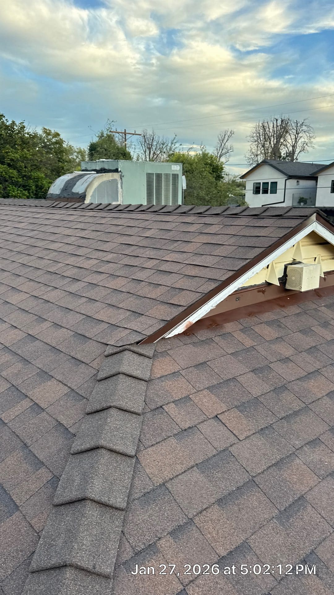 Brown asphalt shingle roof with hip valley and metal flashing detail | Roof Replacement Inc Brown asphalt shingle roof with hip valley and metal flashing detail — Roof Replacement Inc