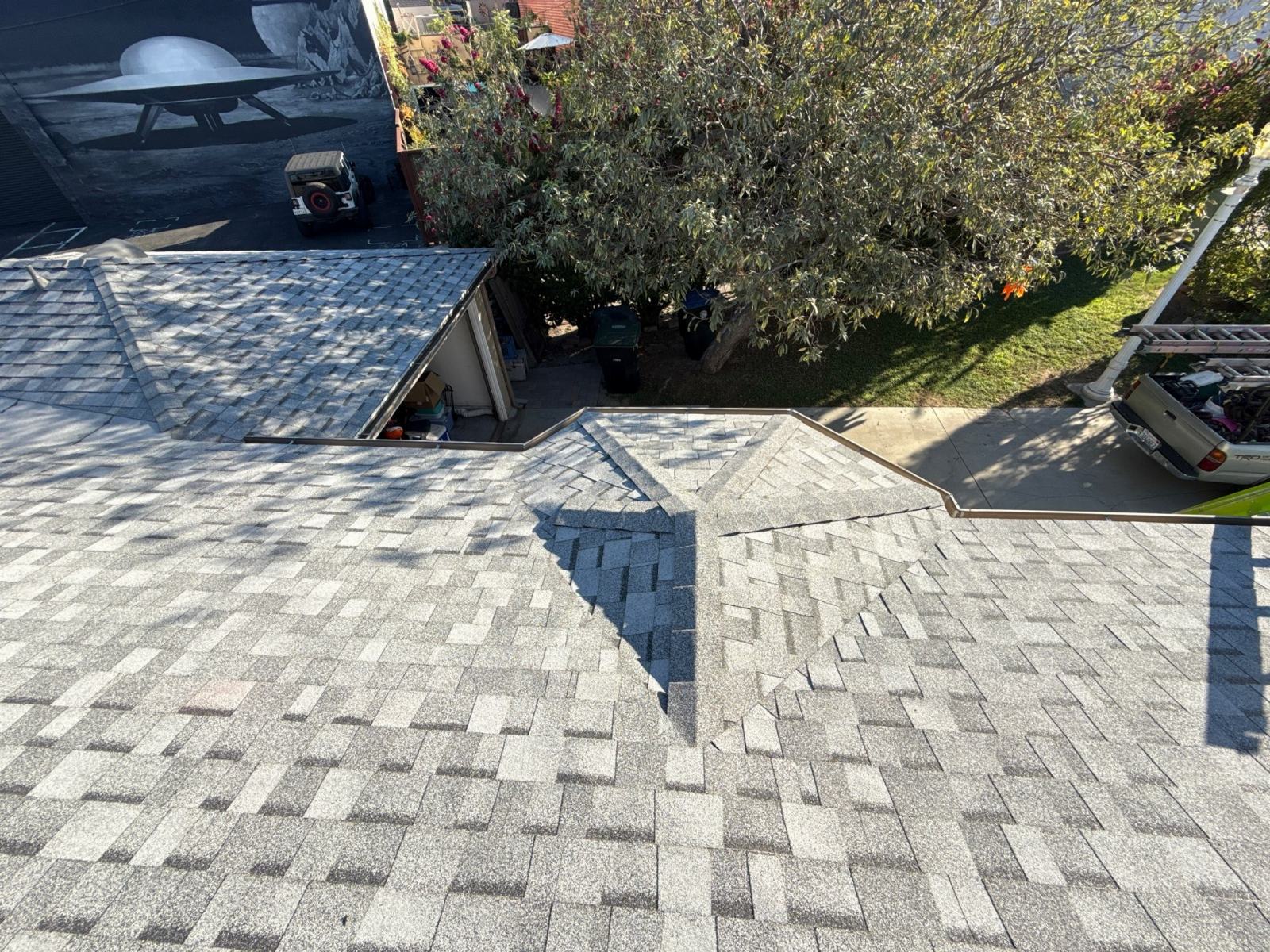 Gray asphalt shingle roof with hip and valley intersections overhead view | Roof Replacement Inc Gray asphalt shingle roof with hip and valley intersections overhead view — Roof Replacement Inc