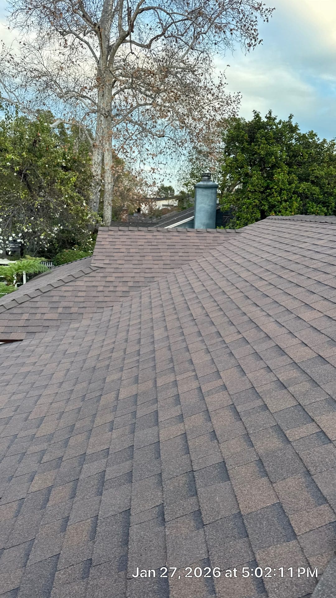 Newly installed brown asphalt shingle roof with metal chimney cap | Roof Replacement Inc Newly installed brown asphalt shingle roof with metal chimney cap — Roof Replacement Inc