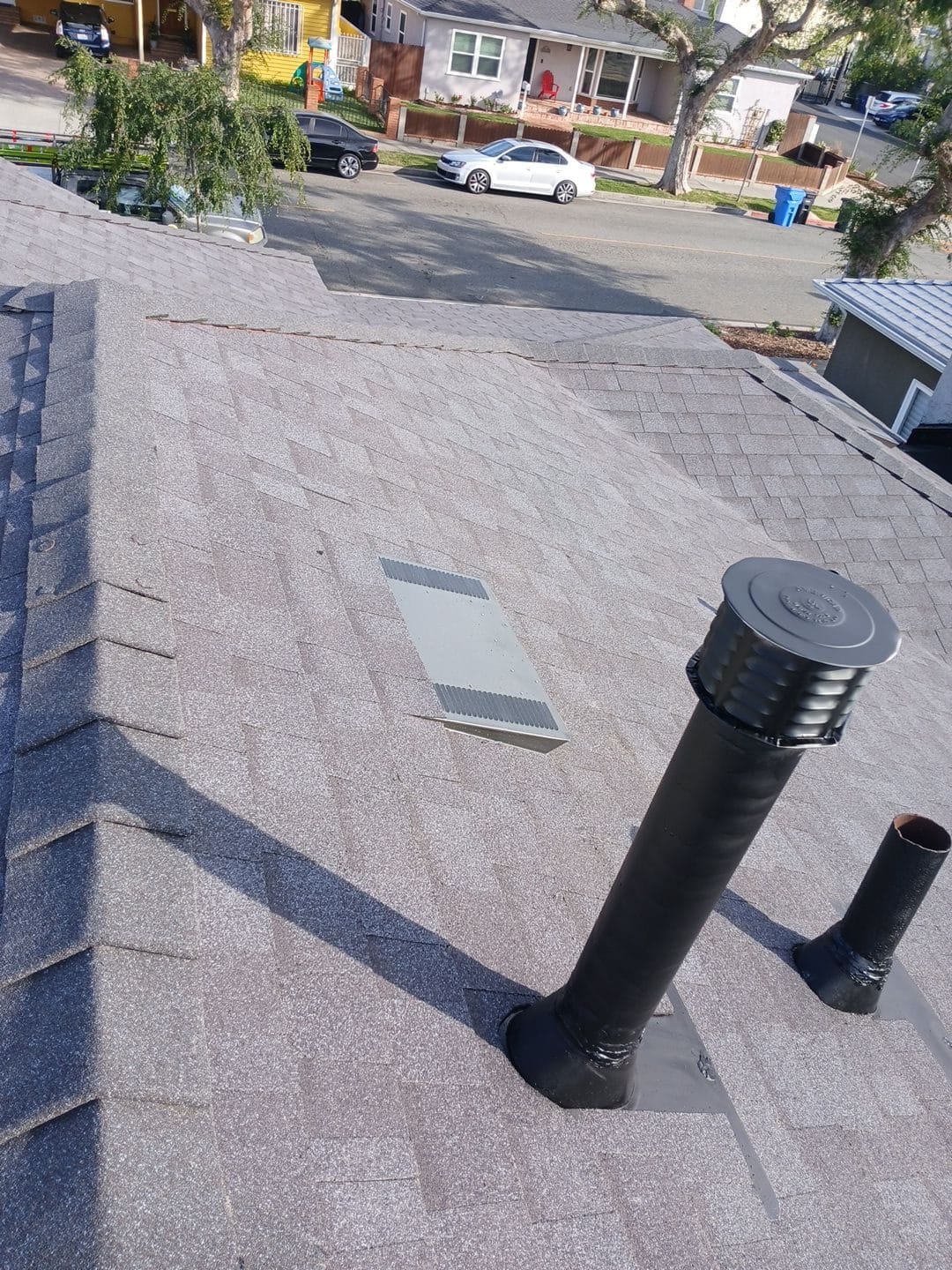 Asphalt shingle roof with chimney pipe, cap, and flat vent | Roof Replacement Inc Asphalt shingle roof with chimney pipe, cap, and flat vent — Roof Replacement Inc