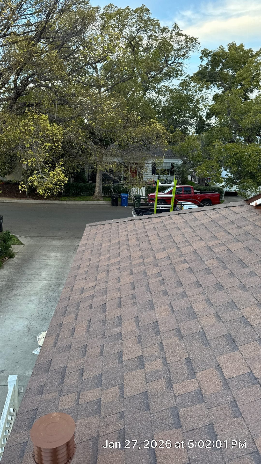 Completed asphalt shingle roof slope with ladder and truck nearby | Roof Replacement Inc Completed asphalt shingle roof slope with ladder and truck nearby — Roof Replacement Inc
