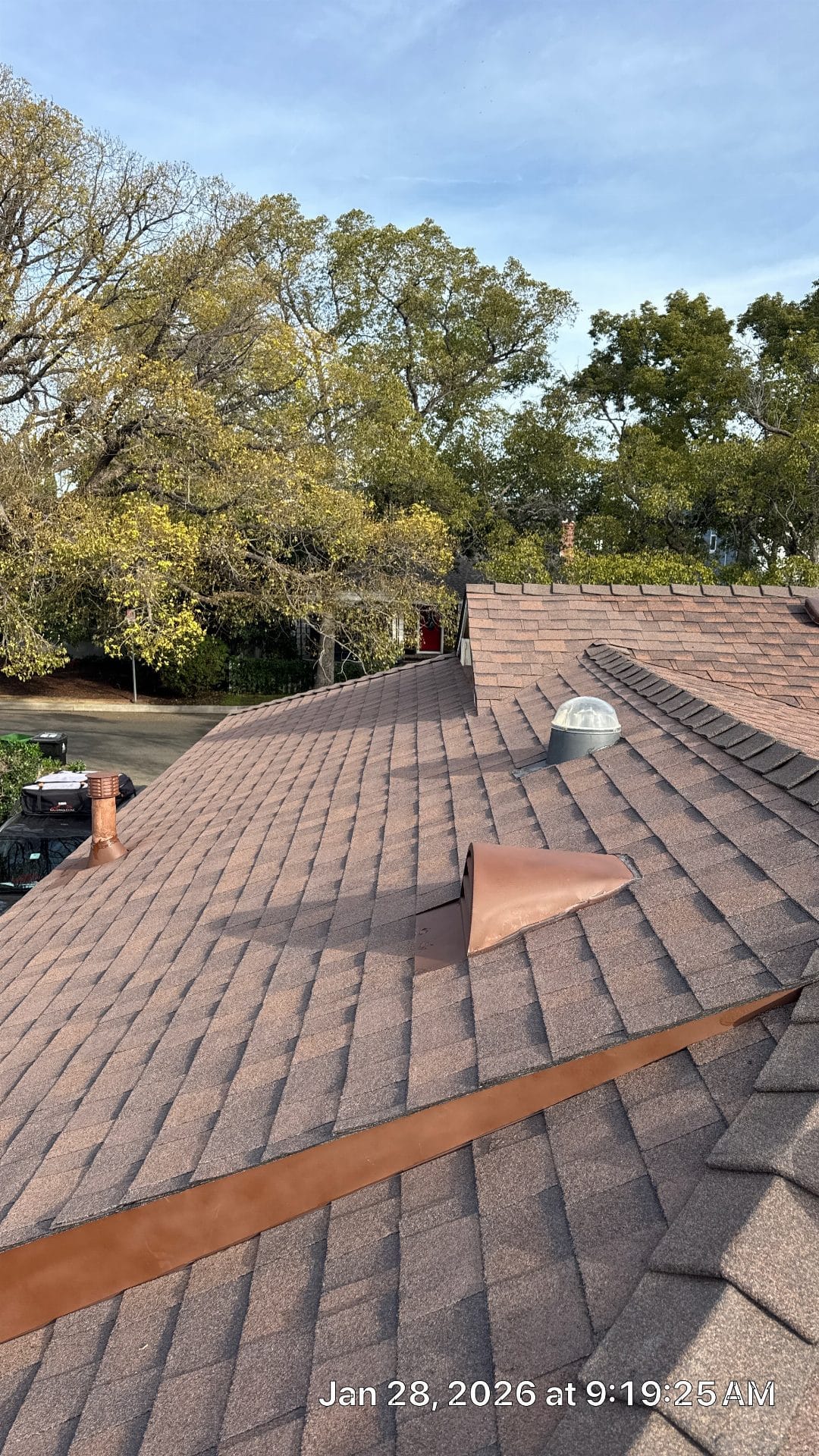 Brown asphalt shingle roof with copper flashing, dome skylight, pipe vent | Roof Replacement Inc Brown asphalt shingle roof with copper flashing, dome skylight, pipe vent — Roof Replacement Inc