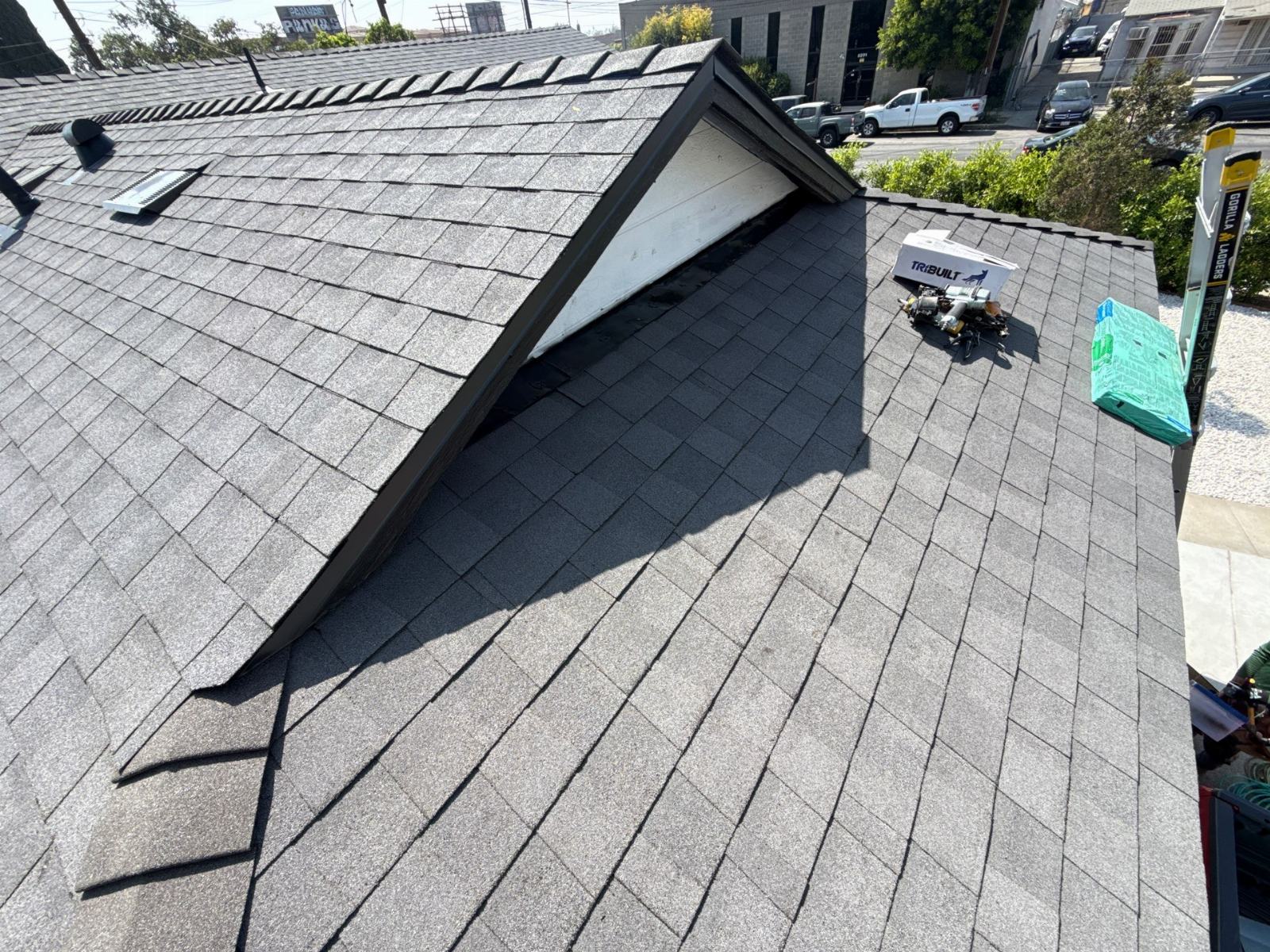 New grey asphalt shingle roof with dormer, TriBuilt materials on deck | Roof Replacement Inc New grey asphalt shingle roof with dormer, TriBuilt materials on deck — Roof Replacement Inc