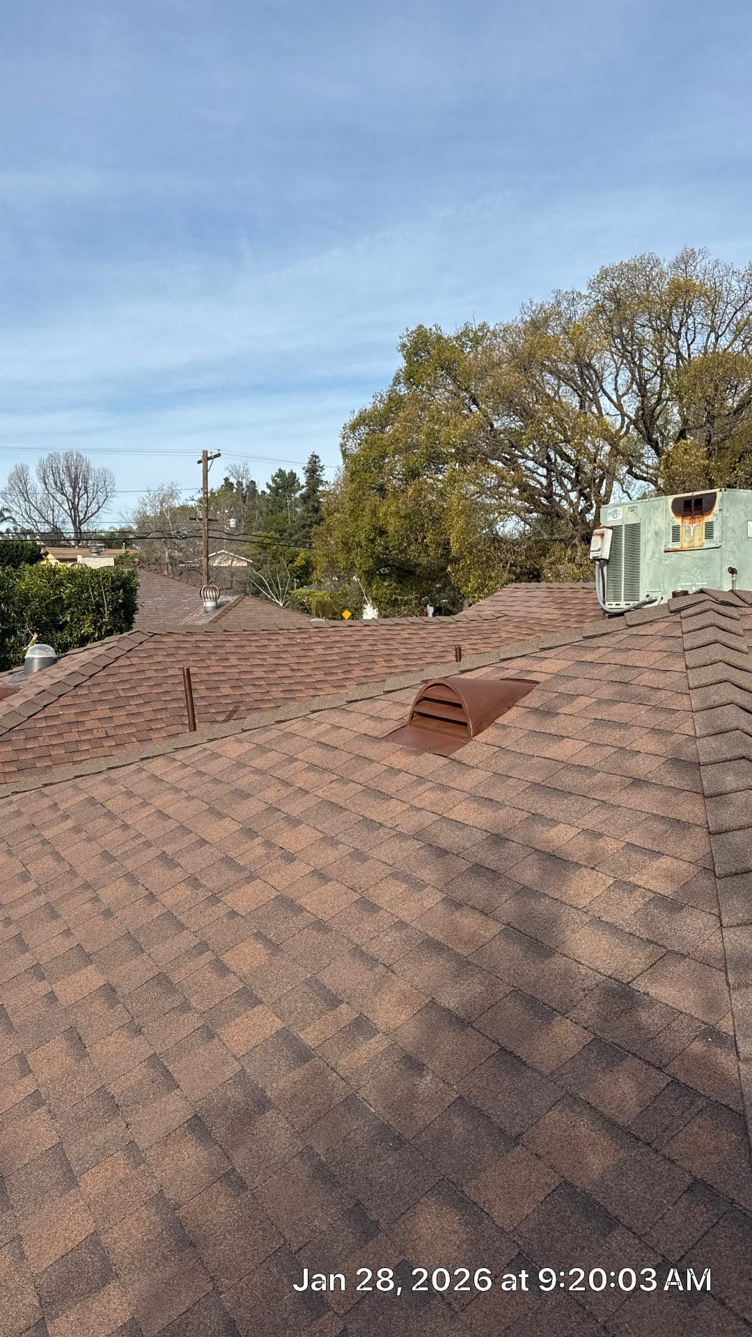 Brown asphalt shingle roof with dormer vent and rooftop HVAC unit — Roof Replacement Inc