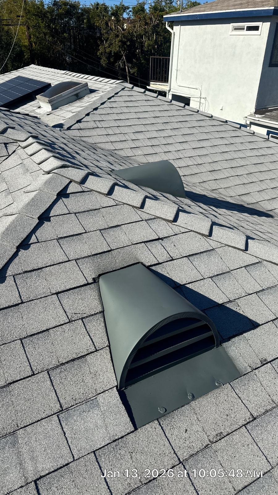 Gray asphalt shingle roof with two exhaust vents installed — Roof Replacement Inc