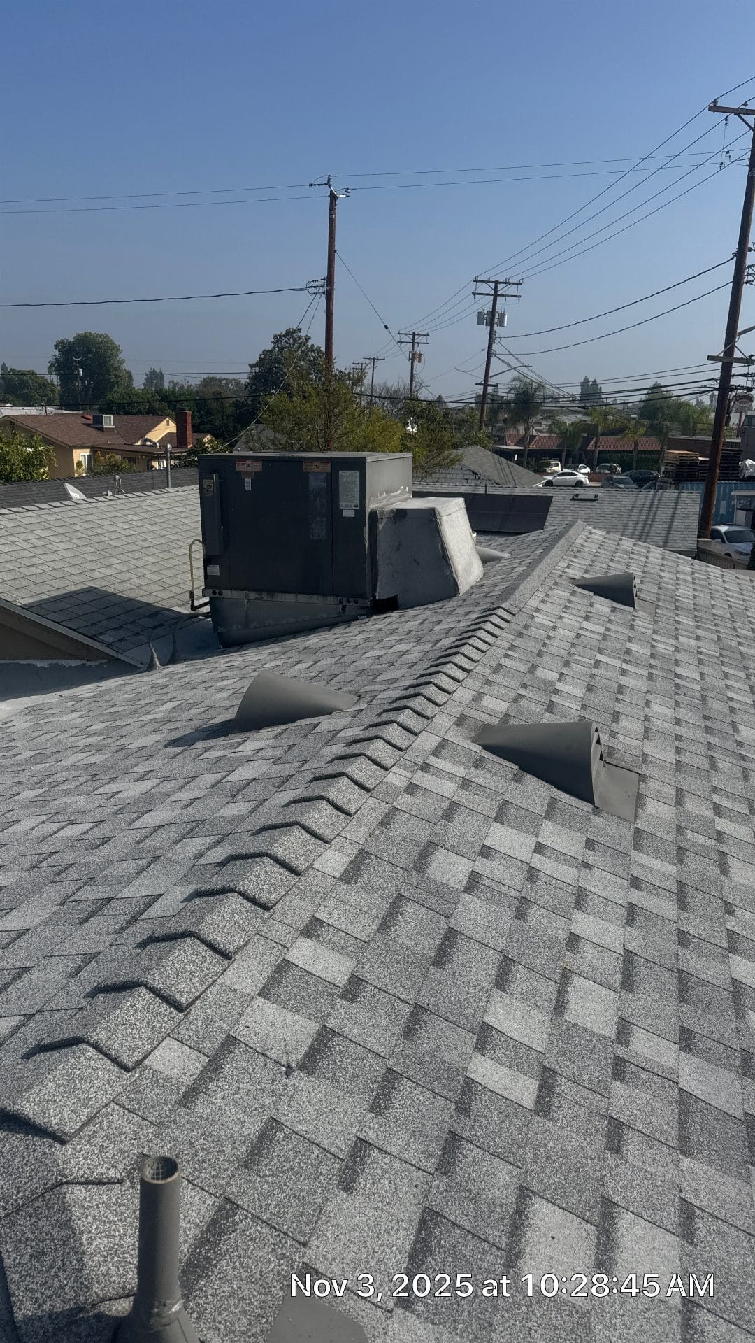New gray asphalt shingle roof with HVAC unit and pipe vents — Roof Replacement Inc