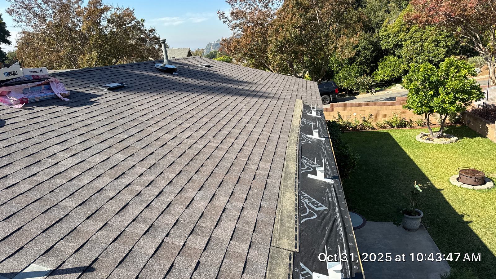 Asphalt shingle roof partially shingled, underlayment exposed at eave edge — Roof Replacement Inc
