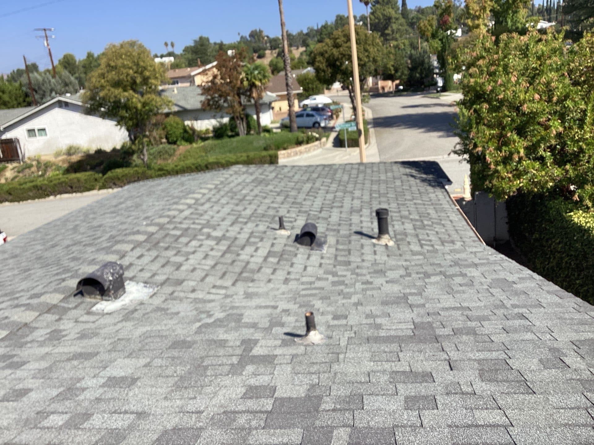gray asphalt shingle roof with pipe boots and vent stacks — Calabasas — Roof Replacement Inc