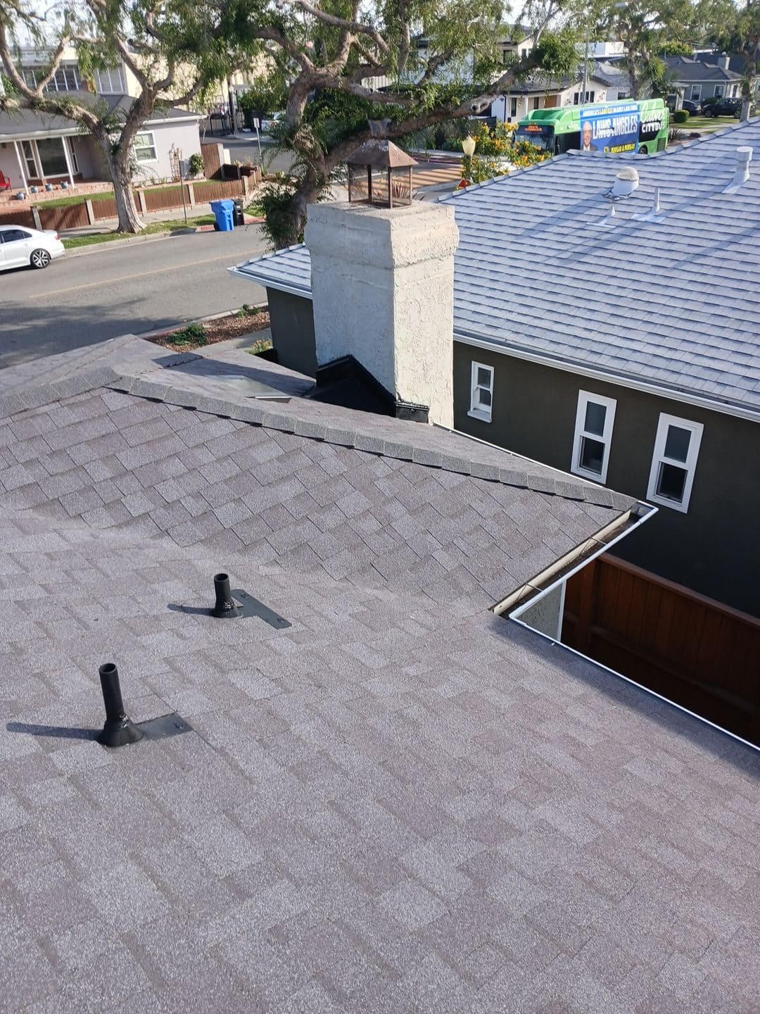 New gray asphalt shingle roof with pipe boots and chimney | Roof Replacement Inc New gray asphalt shingle roof with pipe boots and chimney — Roof Replacement Inc