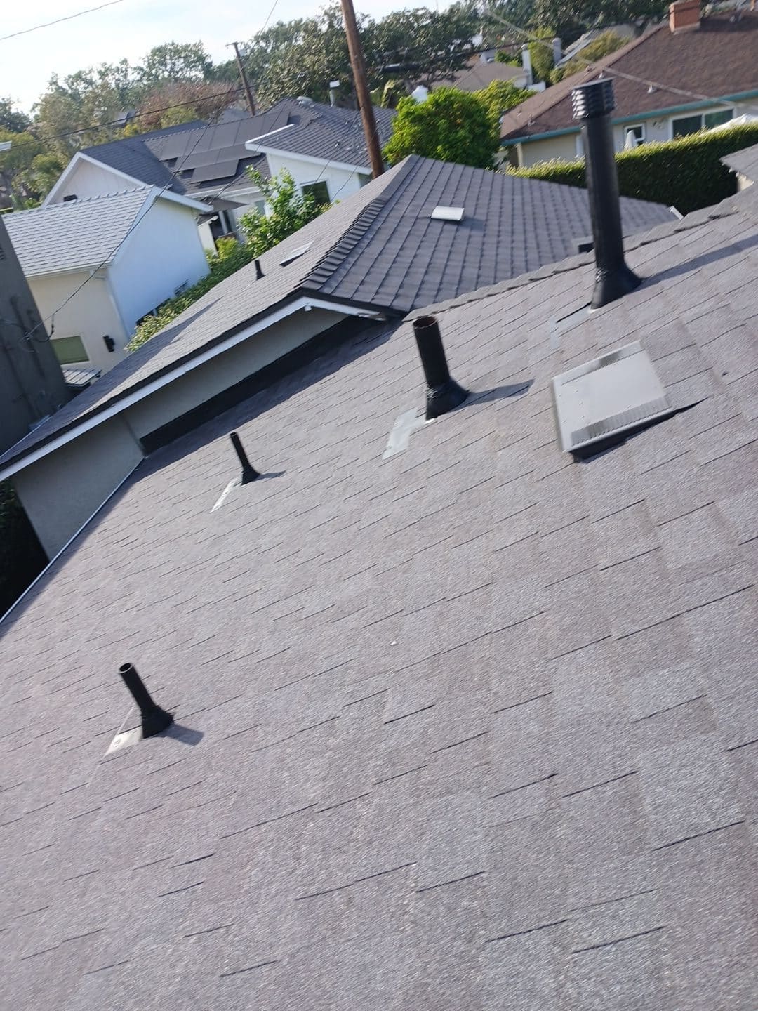 Gray asphalt shingle roof with pipe boots and box vent | Roof Replacement Inc Gray asphalt shingle roof with pipe boots and box vent — Roof Replacement Inc