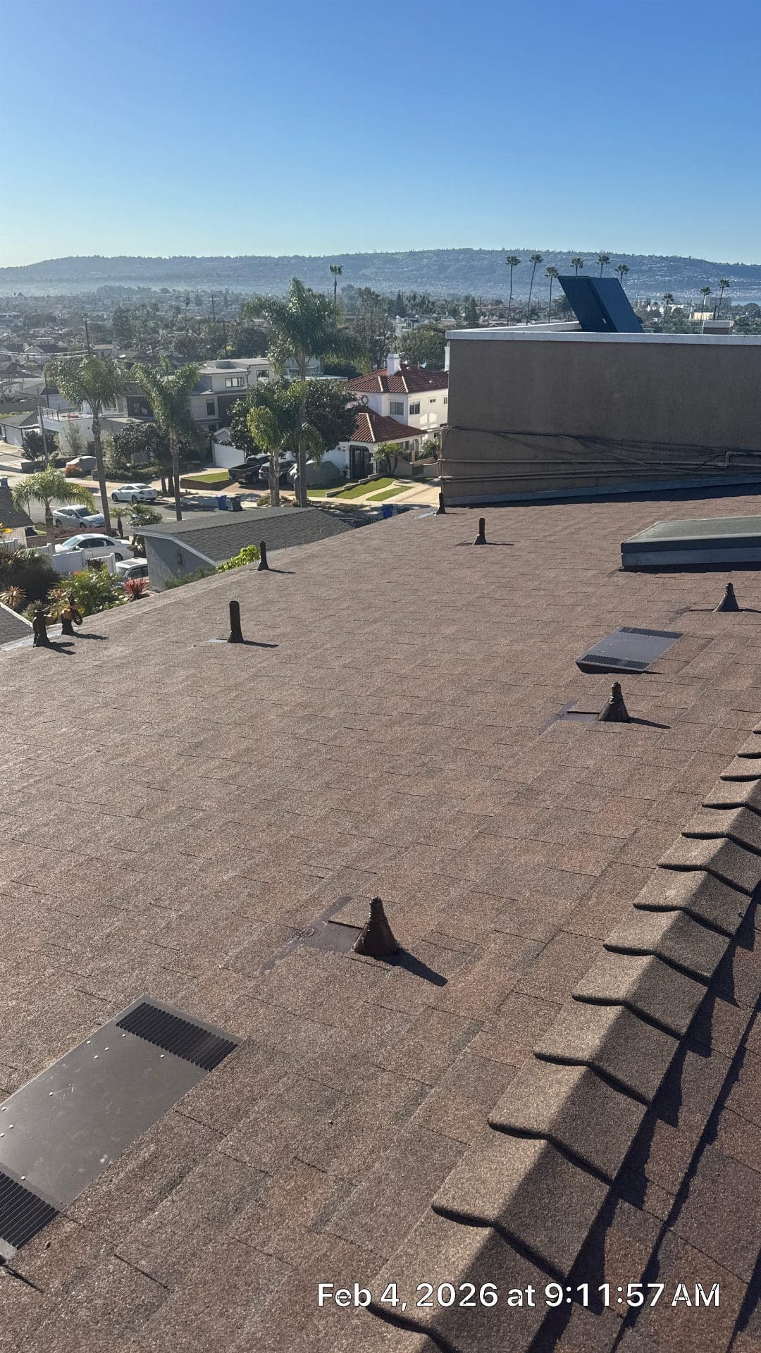 Asphalt shingle roof with pipe boots, skylight, and flat roof section | Roof Replacement Inc Asphalt shingle roof with pipe boots, skylight, and flat roof section — Roof Replacement Inc