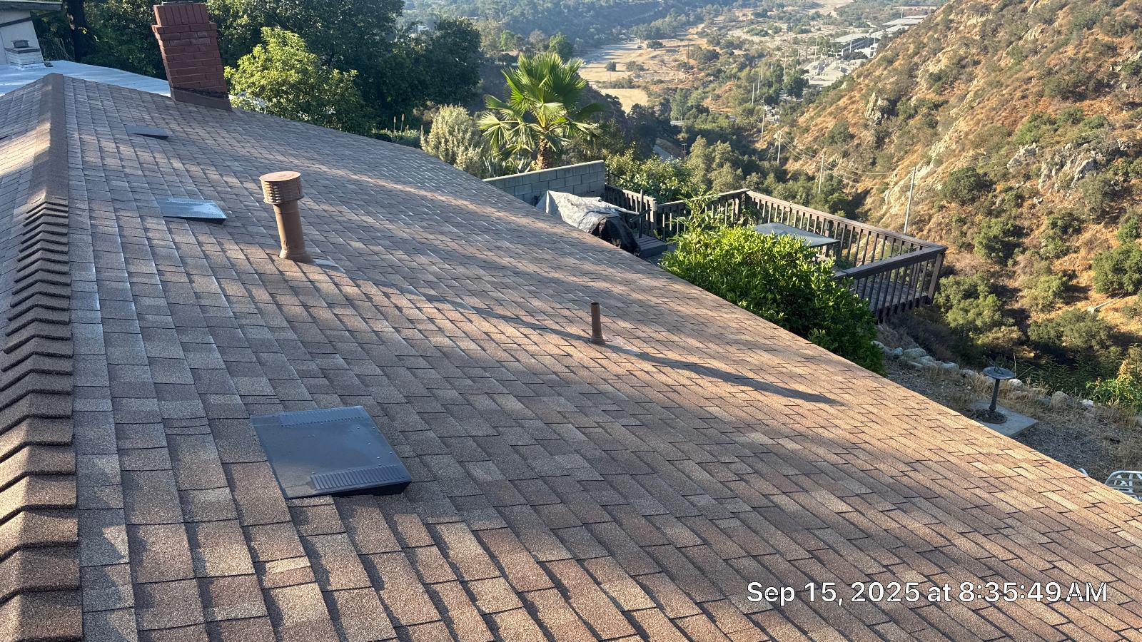asphalt shingle roof with pipe boots and flat vents, hillside view — Altadena — Roof Replacement Inc