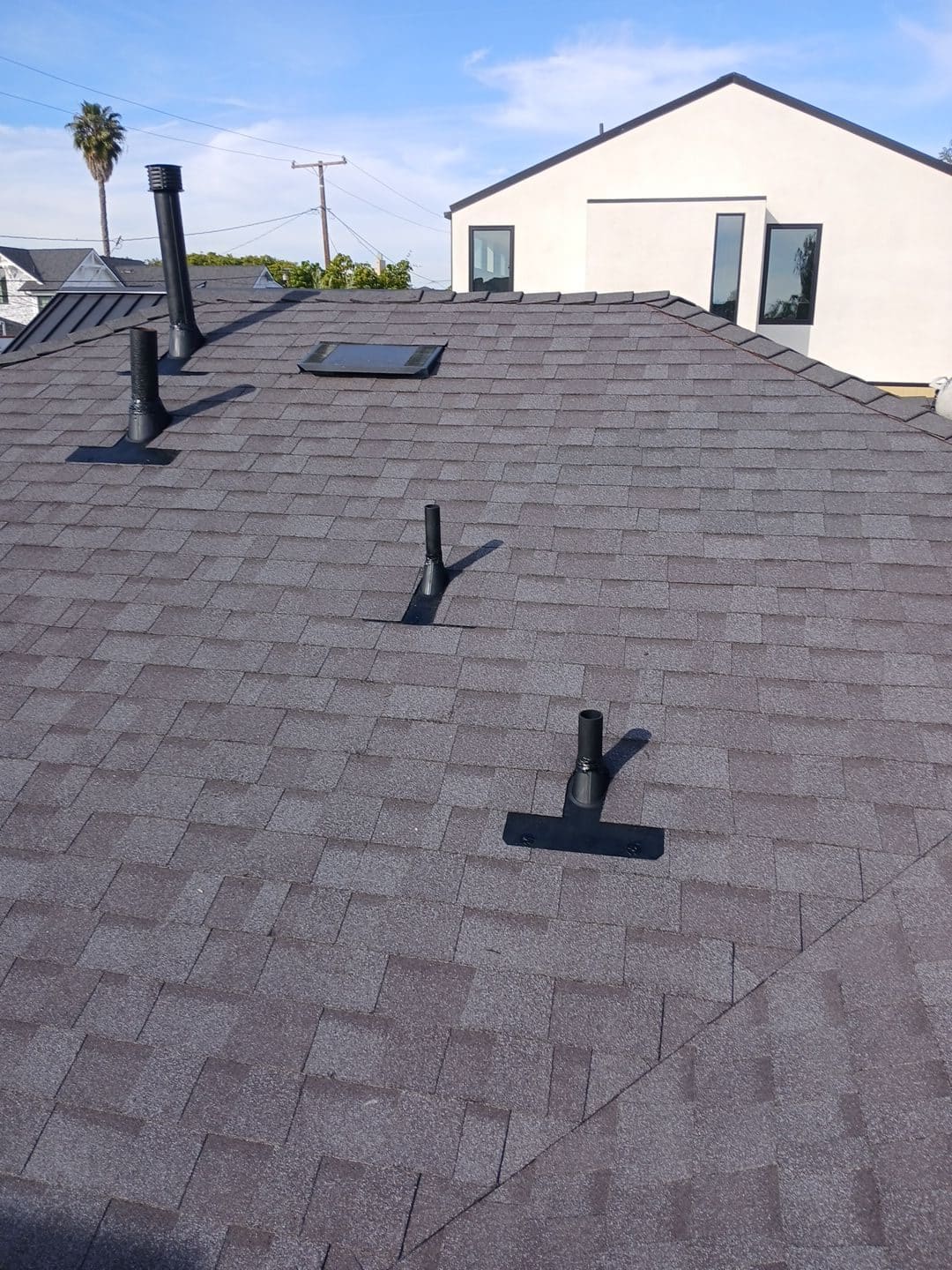 Asphalt shingle roof with pipe mounts, skylight, and vents | Roof Replacement Inc Asphalt shingle roof with pipe mounts, skylight, and vents — Roof Replacement Inc