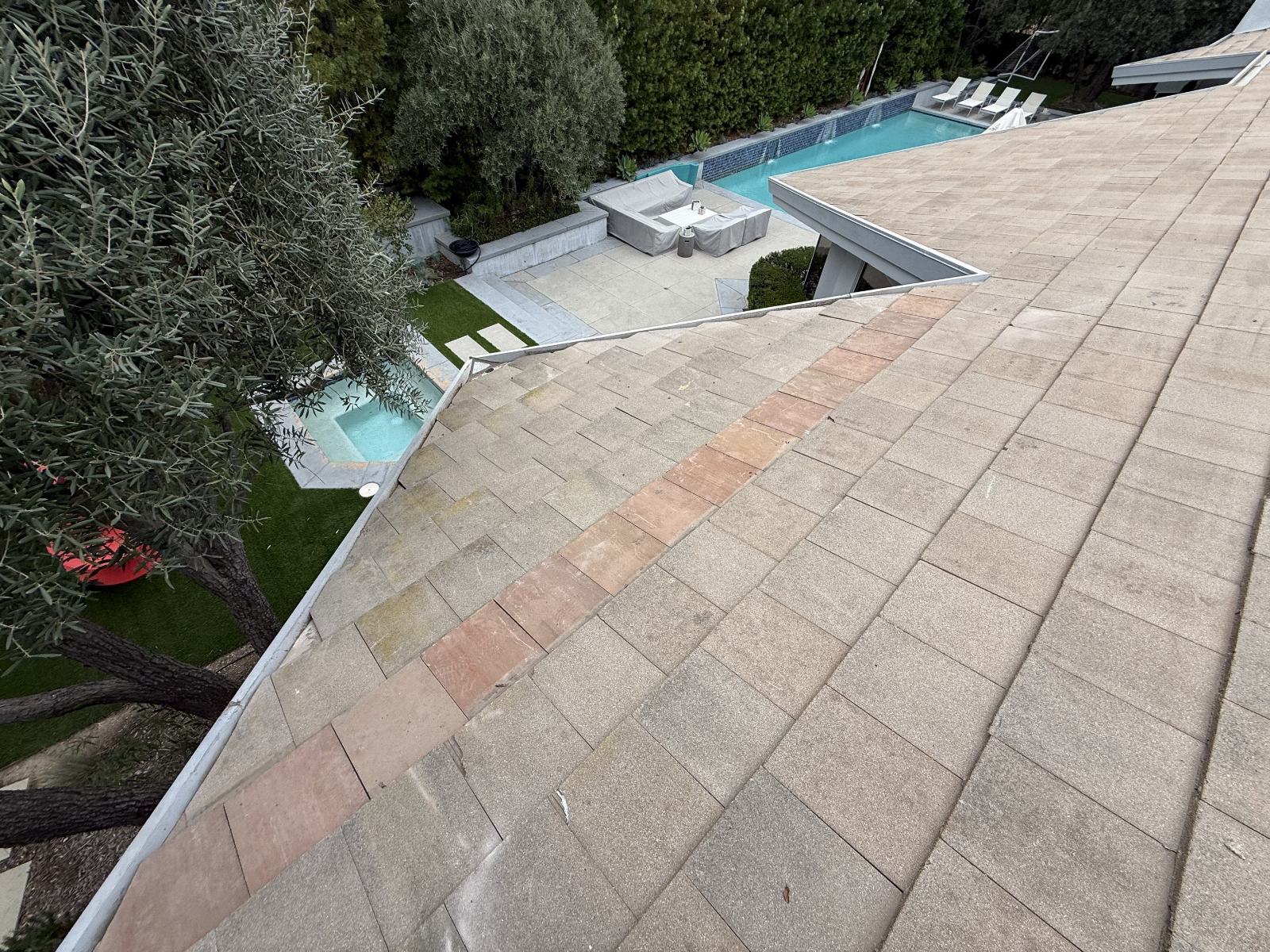 asphalt shingle roof with replacement strip and backyard pool below — Roof Replacement Inc