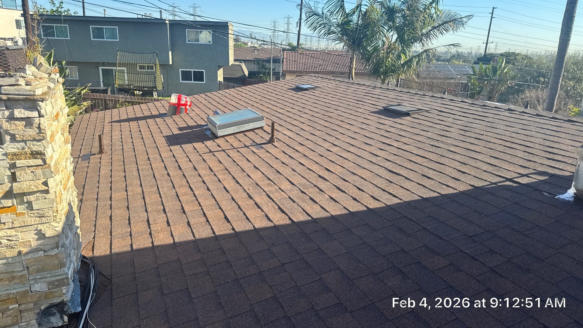 Completed asphalt shingle roof with skylight and roof vent | Roof Replacement Inc Completed asphalt shingle roof with skylight and roof vent — Roof Replacement Inc