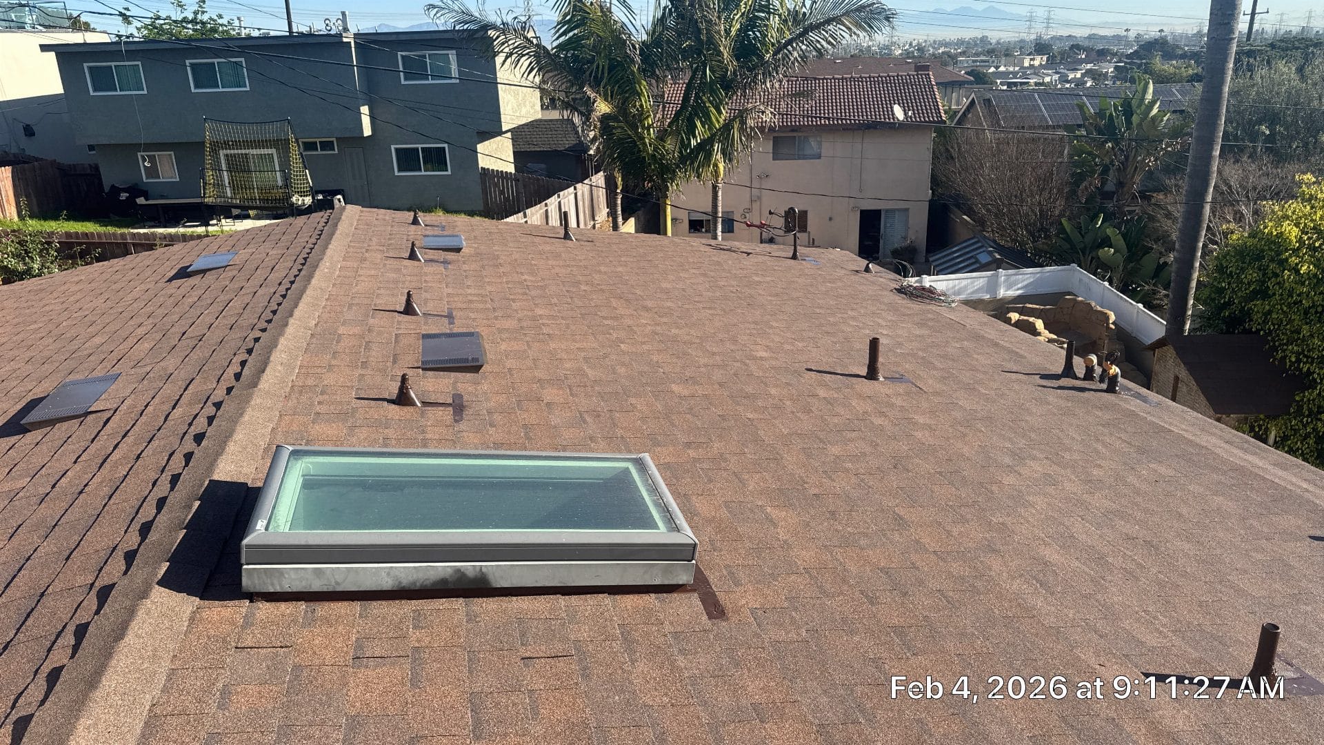 Asphalt shingle roof with skylight, pipe boots, and vents — Roof Replacement Inc