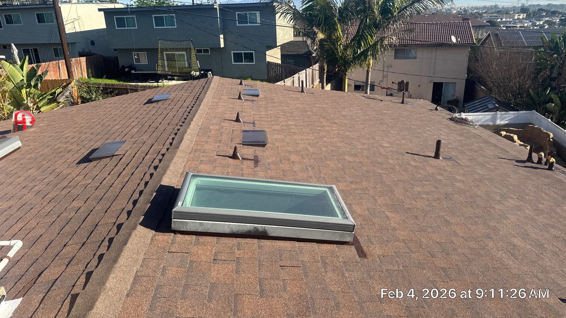 Asphalt shingle roof with skylight, vents, and pipe boots — Roof Replacement Inc