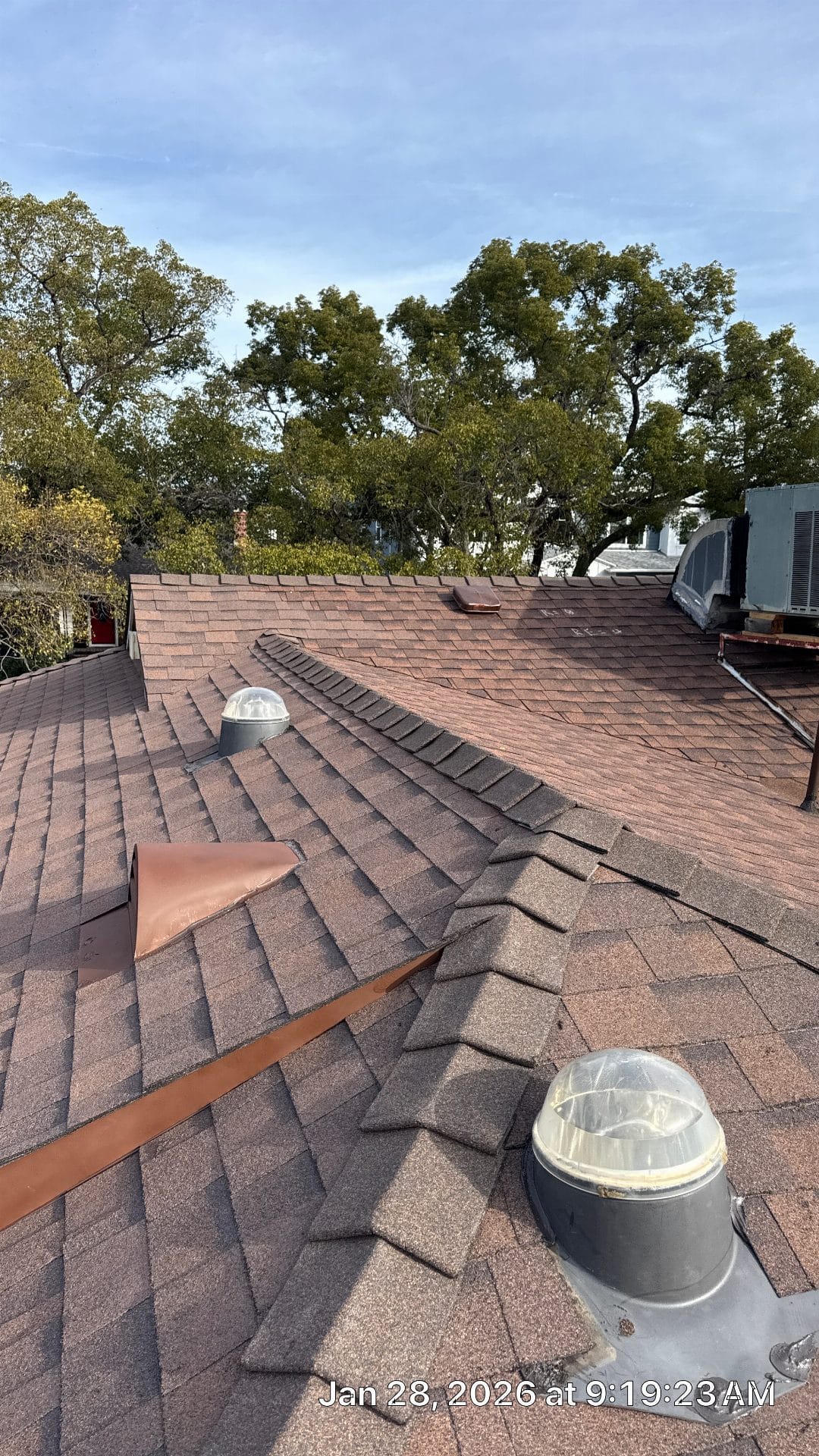 Brown asphalt shingle roof with tubular skylights and copper flashing | Roof Replacement Inc Brown asphalt shingle roof with tubular skylights and copper flashing — Roof Replacement Inc