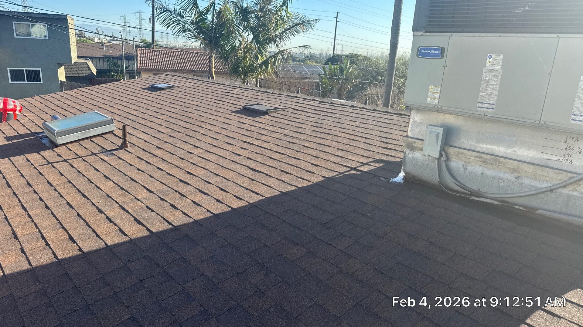 Completed asphalt shingle roof with skylights and rooftop HVAC unit | Roof Replacement Inc Completed asphalt shingle roof with skylights and rooftop HVAC unit — Roof Replacement Inc
